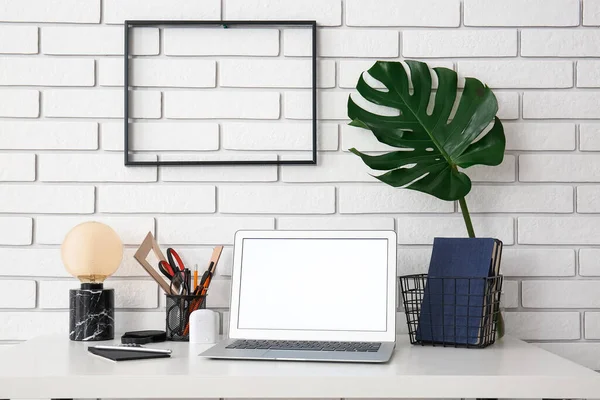 Workplace Laptop Stationery Palm Leaf Vase White Brick Wall — Stock Photo, Image