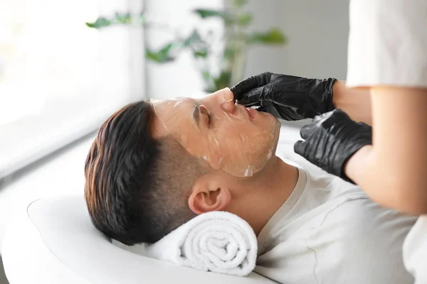 Cosmetologist Applying Gel Mask Young Man Face Salon Closeup — Stock Photo, Image