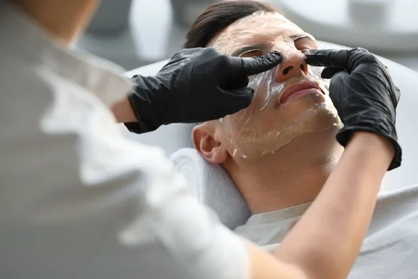 Cosmetologist Applying Gel Mask Young Man Face Salon Closeup — Stock Photo, Image