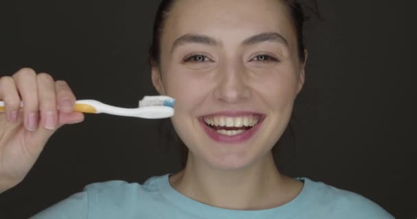 Счастливая Молодая Женщина Чистит Зубы Темном Фоне — стоковое видео