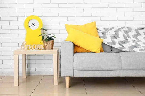 Table Houseplant Alarm Clock Modern Sofa Light Brick Wall Room — Stock Photo, Image