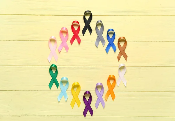 Frame Made Awareness Ribbons Yellow Wooden Background World Cancer Day — Stock Photo, Image