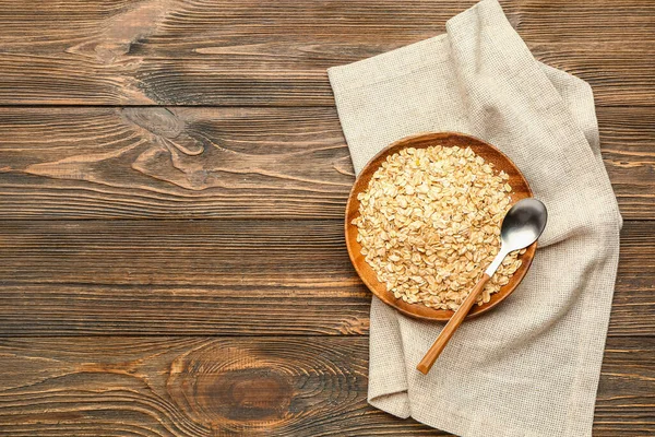 Plate Raw Oatmeal Spoon Wooden Background — Stock Photo, Image