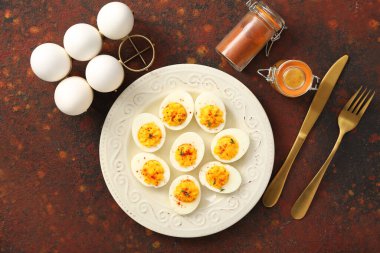 İçi doldurulmuş yumurta, çatal bıçak ve baharatla dolu bir tabak. Paskalya kutlaması