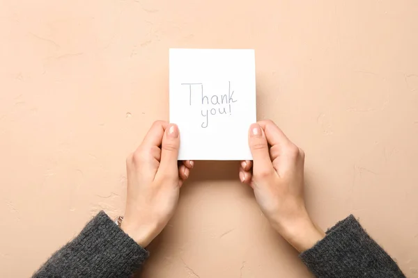 Woman Holding Paper Sheet Text Thank You Beige Background — Stock Photo, Image