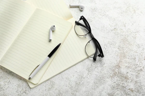 Notebooks Glasses Pen Earphones Light Background — Stock Photo, Image