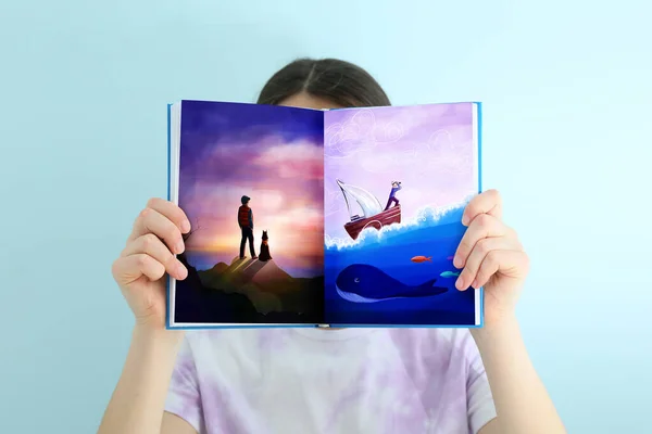 Little Girl Holding Open Book Drawn Seascape Light Background —  Fotos de Stock