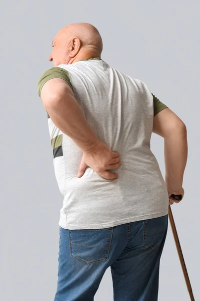Senior Man Walking Stick Suffering Back Pain Light Background — Stock Fotó