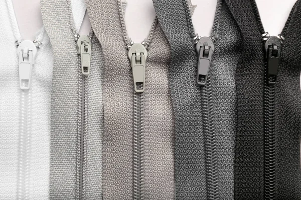 Stylish Different Zippers Light Background — Stock Photo, Image