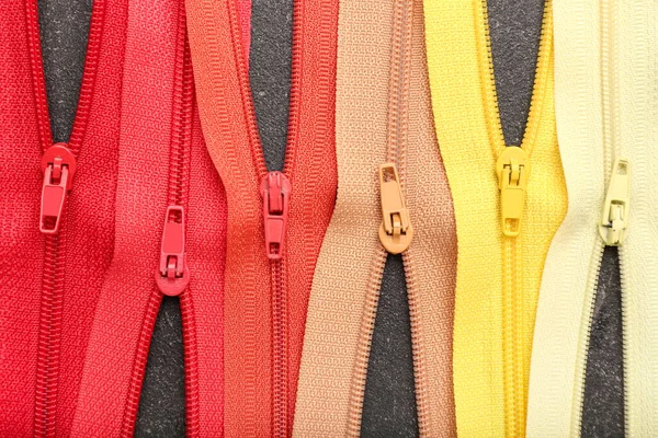 Stylish Different Zippers Dark Background Closeup — стоковое фото