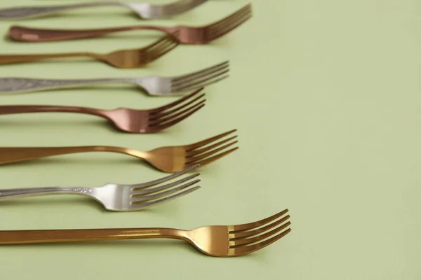 Many Different Forks Green Background — Stock Photo, Image