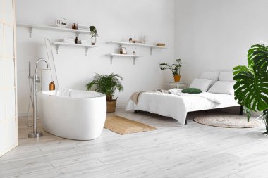 Stylish interior of bedroom with bathtub clipart