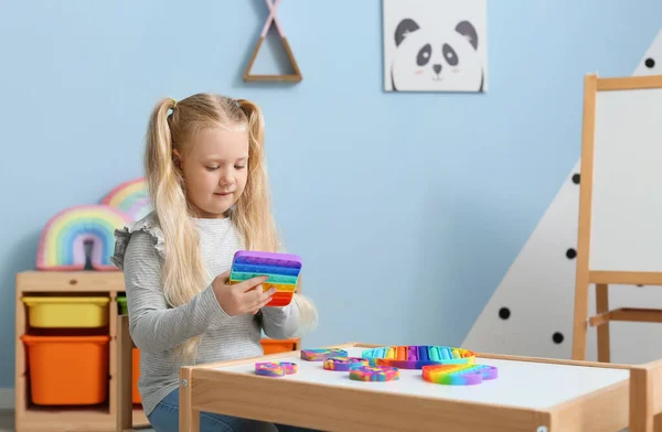 Pretty Girl Sitting Table Playing Multicolored Pop Fidget Toy Child — Stock Photo, Image