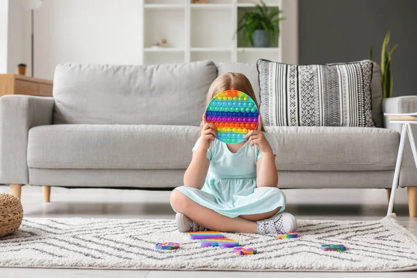 Little Girl Sitting Floor Holding Multicolored Pop Fidget Toy Room — Stock Photo, Image