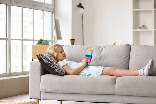 Girl Lying Sofa Playing Pop Fidget Toy Room — Stock Photo, Image