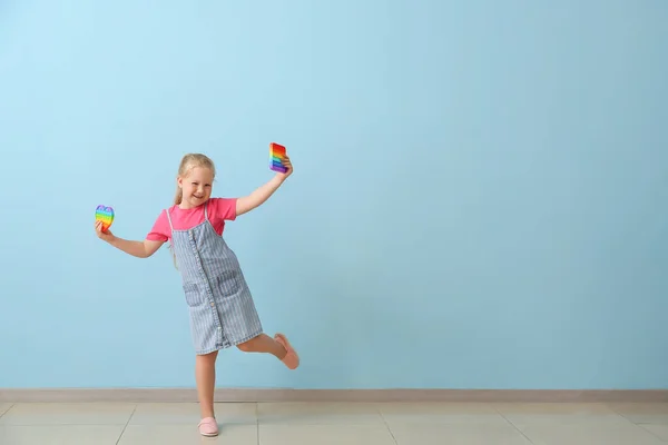Happy Girl Different Pop Fidget Toys Color Wall — Stok fotoğraf