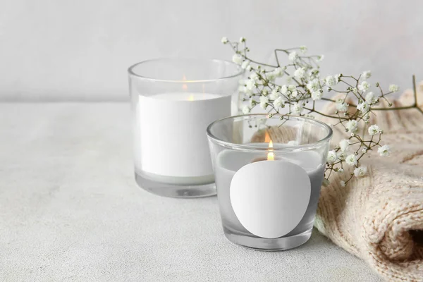 Glass Holders Burning Candles Flowers Sweater Light Background Closeup — стоковое фото
