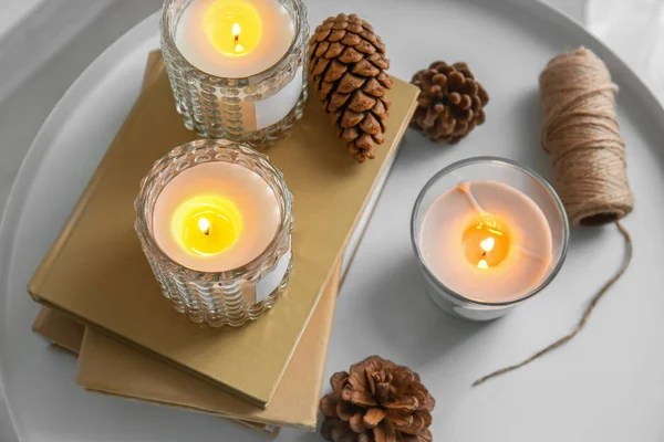 Holders Burning Candles Books Pine Cones Table Closeup — Stock Photo, Image