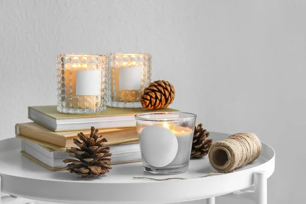 Holders Burning Candles Books Pine Cones Table — Stock Photo, Image