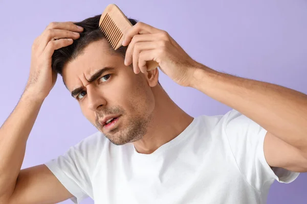 Worried Young Man Combing Hair Lilac Background Closeup — 스톡 사진
