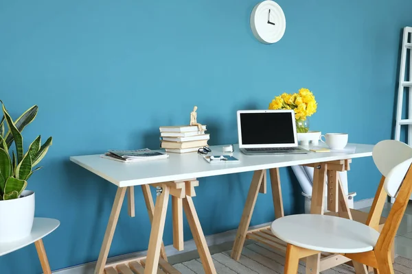 Workplace Modern Laptop Books Vase Flowers Blue Wall Room Interior — Stock Photo, Image