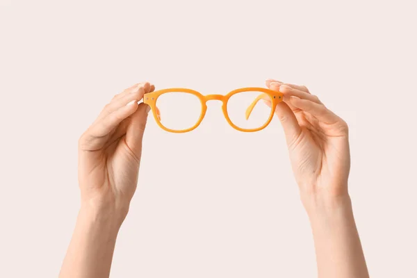 Female Hands Orange Eyeglasses Light Background — Photo