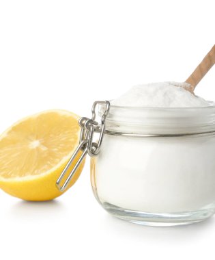 Beyaz arka planda kabartma tozu ve olgun limon kavanozu, yakın plan.