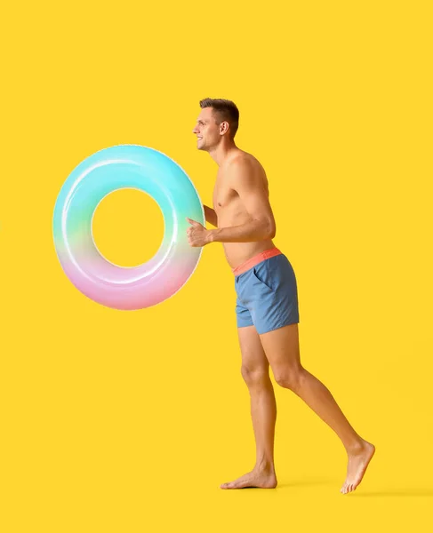 Going Young Man Inflatable Ring Yellow Background — Stock Photo, Image