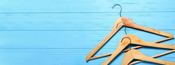 Clothes Hangers Light Blue Wooden Background Space Text Top View — Stock Photo, Image