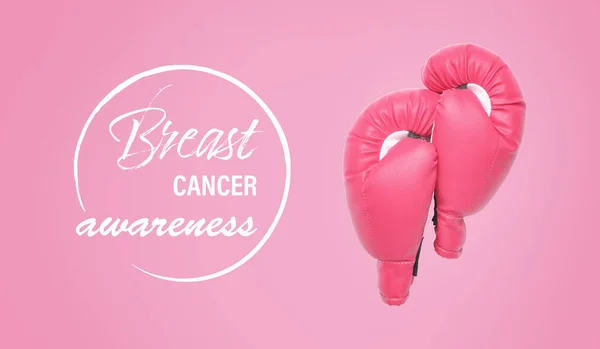 Pink boxing gloves and text BREAST CANCER AWARENESS on color background