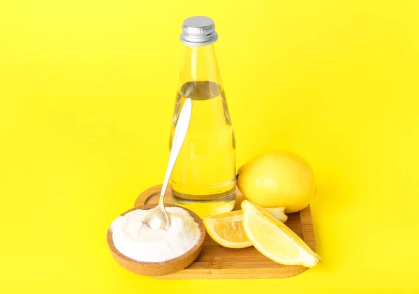 Wooden Board Bottle Water Lemon Baking Soda Yellow Background — Stock Photo, Image