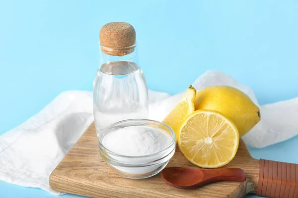 Wooden Board Bottle Water Baking Soda Ripe Lemons Color Background — Foto de Stock