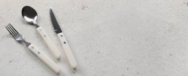 Açık arkaplanda gümüş çatal bıçak seti ve metin için boşluk