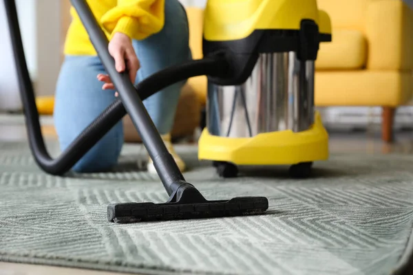 Young Woman Vacuuming Carpet Home — Stockfoto