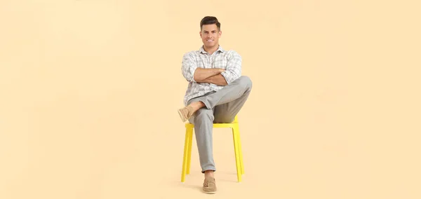 Handsome Young Man Sitting Chair Light Color Background — Zdjęcie stockowe