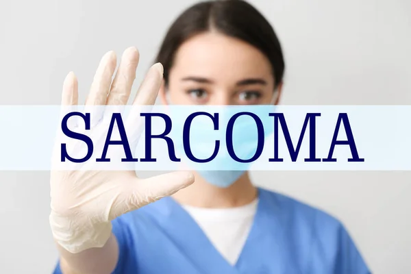 Female Doctor Word Sarcoma Virtual Screen Light Background — Foto de Stock