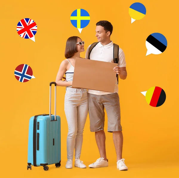 Young Couple Cardboard Suitcase Different Flags Orange Background Travel Concept — Foto de Stock