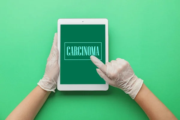 Hands Doctor Holding Tablet Computer Word Carcinoma Screen Green Background — Stock Fotó