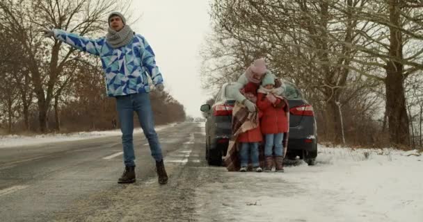 Family Catching Car While Standing Broken Automobile Countryside Road Winter Stock Video