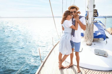 Happy young couple resting on yacht