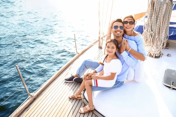 Happy young family resting on yacht