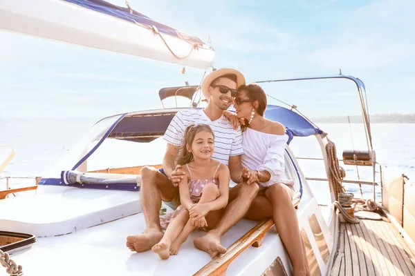 Happy young family resting on yacht