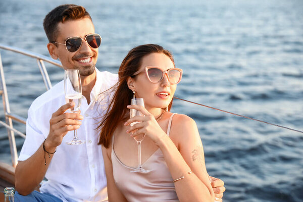 Happy young couple resting on yacht