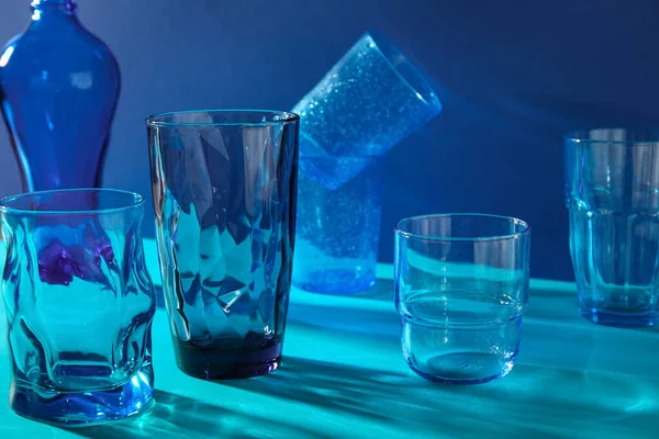 Stylish Empty Glasses Blue Background — Foto Stock