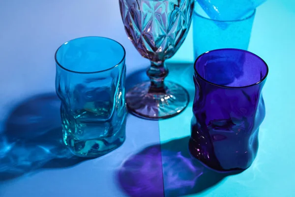 Stylish Empty Glasses Blue Background Closeup — Foto Stock