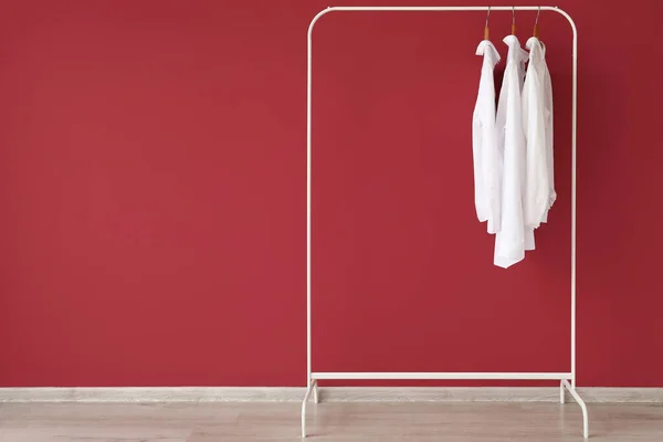 Rack White Shirts Red Wall — Stock Photo, Image