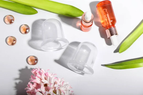 Vacuum Jars Cellulite Massage Bottles Essential Oil Hyacinth Flower White — Stock Photo, Image
