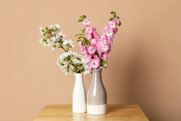 Ceramic Vases Beautiful Blooming Branches Table Beige Wall — Stock Photo, Image