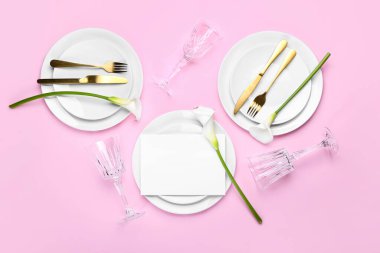 Elegant table setting with calla lilies and blank card on pink background
