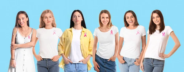 Many women with pink ribbons on blue background. Breast cancer awareness